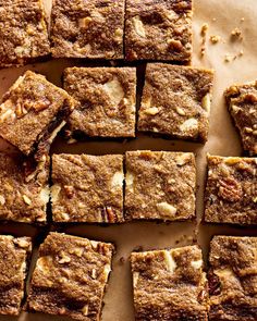 a bunch of brownies sitting on top of a piece of parchment paper next to each other