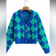 A Slightly Cropped Length Long Sleeve Faux Mohair Cardigan With Dropped Shoulders In The Softest Fuzziest (Never Scratchy Like Actual Mohair!) Bright Green And Blue Harlequin Diamond Pattern --Perfect To Pair With Your High-Waisted Faves For A Cozy Pop Of Color! 85% Acrylic 15% Polyester Trendy Light Blue Winter Cardigan, Fitted Cozy Blue Outerwear, Blue Fitted Warm Outerwear, Fitted Blue Cozy Outerwear, Cozy Blue Fitted Outerwear, Trendy Blue Acrylic Outerwear, Blue Acrylic Outerwear For Fall, Blue Long Sleeve Acrylic Outerwear, Blue Trendy Acrylic Cardigan