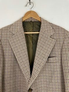 "-Description- >60s Sears men's brown & white loud plaid sport coat >two button front >two buttons on the cuffs >two flap close and one open pocket on the front >double vent in the back >partially lined >built in shoulder pads >polyester >size 40 >one of a kind loud sport coat! >condition: very good for age >color(s): brown, white >fabric(s): polyester >brand: sears >care: dry clean -Measurements- >size: 40 ✩ all measurements are taken with the Retro Brown Tweed Jacket For Business, Retro Brown Tweed Jacket With Notch Lapel, Vintage Plaid Wool Sport Coat, Retro Plaid Business Outerwear, Vintage Wool Plaid Sport Coat, Vintage Plaid Outerwear With Notch Lapel, Vintage Spring Sport Coat With Welt Pockets, Vintage Plaid Single Breasted Sport Coat, Retro Brown Sport Coat With Notch Lapel