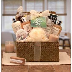 a basket filled with lots of different items on top of a wooden table next to candles