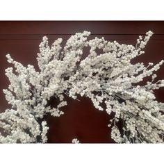 white flowers are arranged in a vase on a table