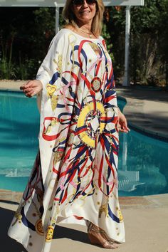 Designer print, summer-white silk caftan. Fun for home or away with its bright colors and lively print on a cool white background. One size. Fits small to X-large sizes. The width is 52 inches from edge to edge or 104 around the body. The length is 51 inches. The neckline is hand finished. Arab Clothes, Silk Beach Dress, Silk Dress White, Silk Kaftan Dress, Long Silk Dress, Silk Caftan, Art Goals, Arabian Dress, White Silk Dress