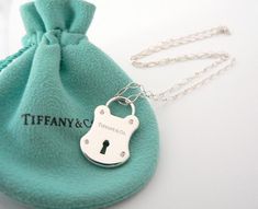 Overview:



 Here
is a gift that she will surely adore!  Offered for sale is a wonderful
Tiffany & Co. Sterling Silver & Diamonds Rectangle Locks charm necklace. Hanging
from its gorgeous Tiffany & Co 18.25 Inch Oval Link chain is a fabulous and very
pretty Rectangle Locks charm accented with 4 Super Sparkly Diamonds!   
I am 100% sure that this is one necklace that will be used a lot! 
Great conversation piece as well - in case you run out of small talk at
a cocktail party.  The Tiffany And Co Padlock Necklace, Tiffany N Co, Lock Charm Necklace, Tiffany And Co Necklace, Padlock Necklace, Small Talk, Gift Love, Tiffany And Co, Sapphire Jewelry