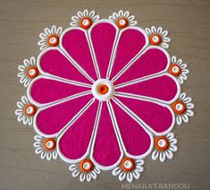 a pink and white flower with orange accents