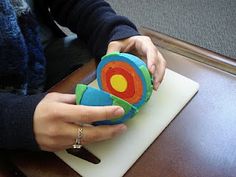 a person holding a toy on top of a table