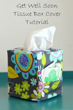 the tissue box cover is decorated with colorful flowers