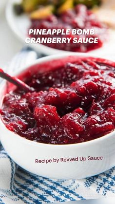 a white bowl filled with cranberry sauce on top of a blue and white towel