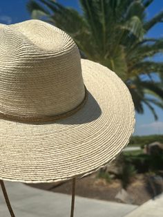 The most beautiful straw panama we've ever carried!! The glamorous Dorado Ritz hat is the perfect straw hat to offer full sun protection. A crystal drawstring that adjusts to tighten, makes this hat all the more fabulous! Its body is braided by artisan hands and interlaced with palm leaves to create the finished design. Hat has a sealer on it making it water resistant. The construction of this hat is incredible. Features an inner elastic band for a OSFM fit! 100% Palm leaf, natural color (One Si Hat Band, Palm Leaf, Palm Leaves, Straw Hat, Elastic Band, Natural Color, Sun Protection, Panama, Most Beautiful