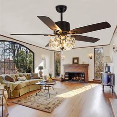 a living room with a couch, fireplace and ceiling fan