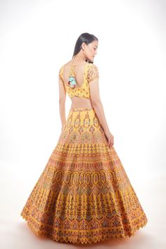 A yellow silk lehenga with fine multi-hued resham embroidery with a touch of sequins and glass beads paired with a matching blouse and mauve pink net dupatta From Chamee and Palak 's The Wedding Edit collectionDELIVERY TIMEPlease allow 8-12 weeks for your outfit to arrive.FABRIC DETAILSSilk And NetProfessional cleaning only. Yellow Silk Lehenga, Wedding Edit, Resham Embroidery, Yellow Silk, Silk Lehenga, Change Image, Yellow And Pink, Net Dupatta, Mauve Pink