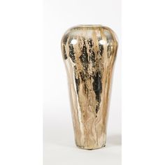 a gold and black vase sitting on top of a white table