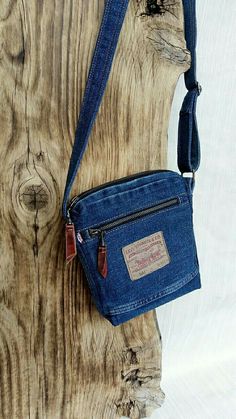 a small blue purse sitting on top of a wooden table