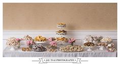 a table topped with lots of different types of cookies and pastries on top of it