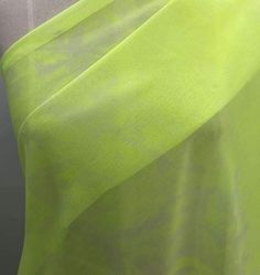 an image of a woman's green dress with sheer fabric on it, close up