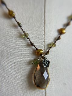 This 18 inch necklace is slightly longer and very pretty on someone with more warm tones to their complexion. Looks great on someone who is richer in color or quite tan, has green eyes or a brunette with warm brown or hazel eyes. Golden freshwater pearls, combined with pinkish bronze crystals and spring green crystals with a warm brown finish, it brightens complexions! Elegant Brown Necklace With Pearl Pendant, Gold Teardrop Pearl Necklace With Gemstone, Brown Pearl Pendant Jewelry Gift, Elegant Handmade Brown Pearl Necklace, Elegant Handmade Golden Brown Jewelry, Brown Pearl Pendant Necklace Gift, Brown Pearl Pendant Necklace As Gift, Brown Pearl Pendant Necklace For Gift, Gift Brown Pearl Pendant Necklace