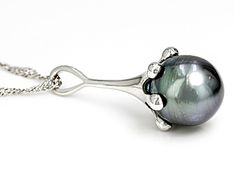 11mm Cultured Tahitian Pearl Rhodium Over Sterling Silver Pendant with Chain. Pendant measures approximately 1 1/4" L x 7/16" W and has a 2.5mm bail. Singapore chain measures approximately inches in length, 1/32 of an inch in width with a lobster claw clasp closure and a 2 inch extender. Colors, shapes, and sizes may vary. Silver Necklace With Bail In Fine Jewelry Style, Formal White Gold Jewelry With Tahitian Pearl, Formal Silver Necklaces With Bail, Formal Tahitian Pearl Pendant Jewelry, Classic Tahitian Pearl Pendant Jewelry, Oval Tahitian Pearl Jewelry For Gift, Tahitian Pearl Teardrop Jewelry For Formal Occasions, Tahitian Pearl Pendant For Formal Occasions, Tahitian Pearl Pendant Jewelry For Formal Occasions