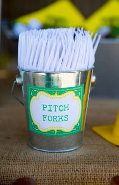 a bucket filled with white paper sitting on top of a table