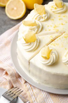 a lemon cake with white frosting and sliced lemons