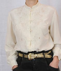 "Stunning one of a kind piece, pure silk ivory blouse. Hand embroidery. Pure silk. Chinese collar. Frog closure. Fits XS-M best (the model has S size frame)  Excellent condition. Measurements: Shoulders  back: 16\" Chest: 20\" All garments are hand washed (or dry cleaned) in eco-friendly detergent.  Please note: Vintage garments are one-of-a kind and may show minimal signs of pre-loved wear, anything major will be noted. Color of product may slightly vary due to lighting. Please enjoy this piece Blouse Hand Embroidery, Frog Closure, Ivory Blouse, Chinese Collar, Girly Stuff, Peasant Tops, Vintage Silk, Silk Blouse, Pure Silk