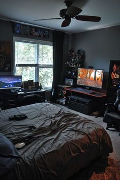 a bedroom with a large bed and two monitors