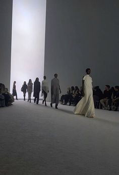 a group of people walking down a runway