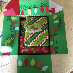 an open christmas gift box on top of a table