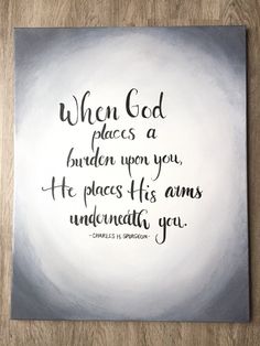 a painting with the words when god places a burden upon you, he places his arms under