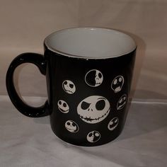 a black and white coffee mug with jack skellings on it's side