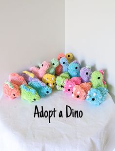 a pile of crocheted stuffed animals sitting on top of a white tablecloth