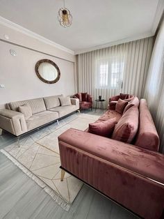 a living room with two couches and a mirror