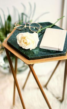 a small table with a book and glasses on it