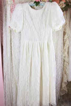 "Vintage 80s 90s beautiful romantic white lace long dress by Karin Stevens. The dress is layered with the lace overlay, padded shoulders, puffy sleeves. Perfect for a tea party, wedding, formal events..etc. Great condition. Pre Loved Great Condition No Stains, Rips, Snags or Holes Note: Missing Belt..it has one belt loop Vintage 80s 90s Brand: Karin Stevens Beautiful White Lace Formal Dress High Collar Neckline Puffy Sleeves Padded Shoulder Floral Lace Overlay..Underneath Acetate Fabric Back Zip Spring Lace Dress For Confirmation, Fitted Lace Dress With Lace Sleeves For Confirmation, White Lace Cottagecore Vintage Dress, Feminine Vintage White Lace Dresses, White Lace Vintage Dress For Garden Party, Lace Trim Dress For Confirmation, White Tea-length Lace Dress, Vintage Lace Dress With Lace Trim And Short Sleeves, Vintage Short Sleeve Lace Dress With Lace Trim