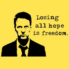 a man in a suit and tie with the words losing all hope is freedom