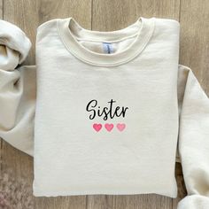 Sister jumper. Sister Sweatshirt. Sister gift Birthday idea. Personalised gift for Sister. Sister gift UK made. This listing is for a high quality bespoke sweatshirt that is a hand made item, made to order. Our Personalised Sister Sweatshirt is handmade with the finest machinery ensuring the ultimate quality for you. Using only premium  sweatshirts, your handmade personalized shirt will be SUPER soft and SUPER comfy Material: Luxuriously soft blend of 80% Cotton and 20% Polyester. Handmade Quality: Crafted with the finest machinery for unmatched quality. Customisation: Personalise with names! Add details in the 'personalisation section' at checkout. (Note: Exact spelling as provided will be used.) Design Options: Choose between printed or blank styles. How to Order ❤️ Select the colour and Custom Text Long Sleeve Sweatshirt As A Gift, Personalized Sweatshirt Gift, Personalized Sweatshirt For Gift, Personalized White Sweatshirt For Gift, Personalized Name Print Sweatshirt As Gift, Personalized Long Sleeve Sweatshirt As Gift, Personalized Long Sleeve Sweatshirt Gift, Personalized Name Print Long Sleeve Sweatshirt, Personalized Casual Long Sleeve Sweatshirt