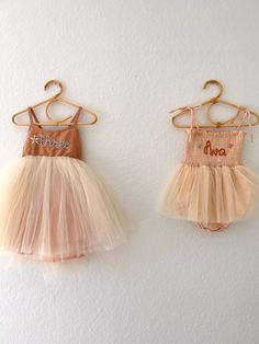 "Rose colored tutu dress comes in sizes 3M-4T with tie back straps.  Cream colored tutu romper comes in sizes 3-12 months and comes with tie shoulder straps.  Both pieces are personalized with number or name hand embroidery. Designs may be added for additional charge using the \"add a design\" listing. Please choose thread color and leave the name in the custom box. Personalized embroidery of number or name has a maximum number of characters of 6. Thread color comes in Pink, Periwinkle, Rust, Mustard, White, Lavender, Blue. Care: Handwash with mild soap and lay flat to dry for best results." Whimsical Summer Tutu Dress With Tulle Skirt, Whimsical Sleeveless Summer Tutu Dress, Cute Tutu Dress For Baptism In Summer, Whimsical Summer Tutu Dress For First Birthday, Summer Balletcore Tutu Dress With Tulle Skirt, Summer Balletcore Tutu Dress, Fitted Tutu Dress For First Birthday In Summer, Princess Style Tutu Dress For Baptism In Summer, Sleeveless Fitted Tutu Dress For First Birthday