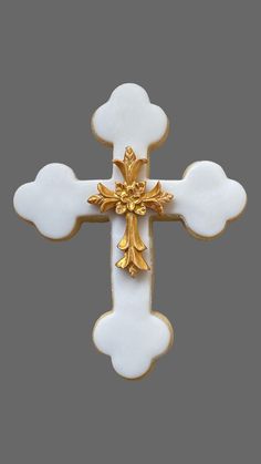 a gold and white cross on a gray background