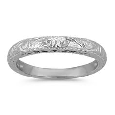 an engraved wedding band with leaves and scrolls on the sides, in white gold or silver