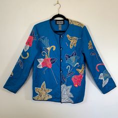 New With Tags Lined Blazer/Jacket, Floral Embroidered Design, Wearable Art, Size Medium (10-12), Bust 37 - 38.5, Waist 28 - 29.5, Hips 38.5 - 40, 5 Lucite Button Front Closure, Extra Button Sewn Inside Seam, Taped Shoulder Seams To Control Stretch, Color: Blue Pink Yellow White Purple Cream Black Embroidery, Shell 52% Cotton 48% Rayon, Lining 100% Polyester, Made In India, Subtle Interior Sewn In Shoulder Pads, In Excellent Condition Festive Blue Long Sleeve Outerwear, Festive Blue Outerwear For Fall, Festive Blue Outerwear With Floral Embroidery, Festive Long Sleeve Casual Outerwear, Festive Long Sleeve Outerwear For Spring, Blue Long Sleeve Outerwear For Festive Occasions, Casual Long Sleeve Festive Outerwear, Casual Festive Outerwear, Festive Blue Floral Embroidery Outerwear