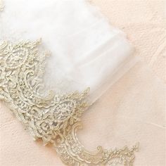 an image of wedding garter laying on the ground with it's lace edge