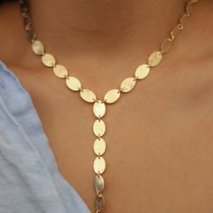 -18k gold plated long necklace with small ovals cascading down in the center -Measures 18" -Handmade in Brazil -Please note that our brand uses natural semi-precious stones--each piece has a unique texture, shine, and color Handmade Yellow Gold Lariat Jewelry, Elegant Adjustable Oval Pendant Necklace, Gold Brass Lariat Necklace, Adjustable Dainty Oval Necklace, Adjustable Oval Dainty Necklace, Dainty Handmade Gold Lariat Necklace, Dainty Gold Handmade Lariat Necklace, Handmade Long Drop Lariat Necklace, Elegant 14k Gold-filled Oval Link Necklaces