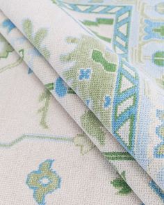 two pieces of fabric with blue and green designs on them