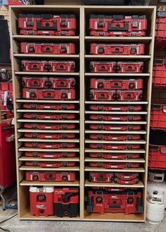 the shelves are full of red tool boxes