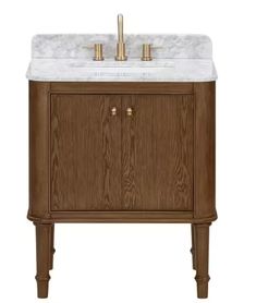 a bathroom vanity with marble top and two faucets