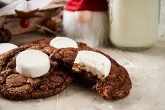 two cookies with marshmallows are on the table