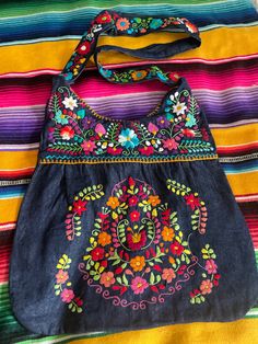 Beautiful Mexican embroidered bag !  Made of denim fabric. Bag is lined inside and has a small zipper  compartment inside.  All measurements are showing in all pictures please take a look before ordering.  If need to wash please only hand wash and hang to dry.  NO RETUNS OR EXCHANGES ON BAGS. Casual Embroidered Shoulder Bag, Embroidered Cotton Shoulder Bag For Everyday Use, Casual Embroidered Hobo Bag, Embroidered Blue Shoulder Bag For Everyday Use, Casual Embroidered Crossbody Bag, Casual Embroidered Crossbody Shoulder Bag, Blue Embroidered Summer Shoulder Bag, Blue Embroidered Shoulder Bag For Everyday Use, Summer Blue Embroidered Shoulder Bag