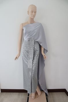 Silver-greenish gray  Thai/ Khmer outfit, "Chut thai" for women.  Occasions: Songkran festival, Loy krathong festival, bride made dress, Thai fair, Thai exibition, attended Thai wedding, temple ceremony, making merit etc. The set consists of 1.A wrap around skirt made from brocade faux silk fabric, the skirt can be adjust by hooks         Waist: 24-32 in. (61-81 cm)   Hips: 34-42 in. (86-107 cm)    Length: approx. 36.5 in. (92 cm) 2.Satin plain color Thai shawl/ sabai     Measurement: 18 in. x 118 in. (45 cm x 300 cm)  Care instructions:  Hand wash or machine wash on gentle cycle. Separately for excessive dye. Hang to dry under shade for extra care of its color.  Note:  -Due to the difference between different monitor, the picture will not reflect the actual color of the item. We guarantee Khmer Party Dress, Khmer Outfit, Adjustable Skirt, Loy Krathong, Khmer Dress, Songkran Festival, Thai Wedding, Festival Bride, Sarong Skirt