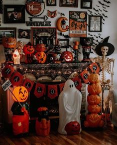 a fireplace decorated for halloween with pumpkins and ghost decorations