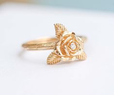 "ღ Immediately fell in love with!. This Rose Flower ring, This ring carved shaped as a rose flower and was also decorated with Natural Diamond and were elaborately installed on the ring by skilled craftsmen, On the surface wood carving pattern. Which makes this ring definitely unique. ♦ Description Product ♦ ✦ MAIN STONE DETAIL ✦  ➤  Main Stone : Natural Diamond ➤ Size: 1.3 mm ➤ Weight : 0.01 carats ➤  Clarity : VVS ➤ Shape : Round ➤  Color : D color  ➤ Cut Grade : Belgium Cut ✦ FLOWER SIZE  ✦ BAND DETAIL ✦ ➤  Flower Size : 7.0 mm ➤ Band Width：1.8 mm ➤ Band Thickness : 1.5 mm ✦ MATERIAL ✦ WEIGHT ✦ ➤ Material Gold : 10K Gold , 14K Gold , 18K Gold ➤ Rose Gold - Yellow Gold - White Gold ( Plated Rhodium ) /  Platinum 950 ➤ Weight of Gold : 10K Gold ➢ 2.0 - 2.5 Gram , 14K Gold ➢ 2.6 - 3.0 Gram Rose-colored Fine Jewelry Flower Ring For Anniversary, Elegant Floral Rings With Rose Details, Rose Flower Ring For Anniversary, Fine Jewelry, Rose Flower Ring For Wedding, Rose Detail Jewelry For Wedding, Delicate Rose Design Flower Ring For Wedding, Rose Design Flower Ring For Anniversary, Heirloom Rose Gold Flower Ring, Exquisite Flower-shaped Ring For Anniversary