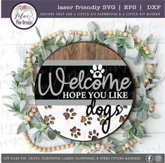 a wooden sign that says welcome hope you like dogs with paw prints on the front