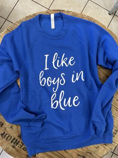 "The \"I like boys in blue\" sweatshirt is a must have.  This adorable design is on a super soft royal blue, poly blend Bella Canvas sweatshirt. The sweatshirt has a unisex fit making it run true to size.  This will quickly become your favorite Kentucky sweatshirt.  We use high quality Bella Canvas sweatshirts." Kentucky Sweatshirt, Blue Basketball, Kentucky State, University Of Kentucky, Kentucky Wildcats, Blue Sweatshirt, White Collar, Design Company, Cute Shirts